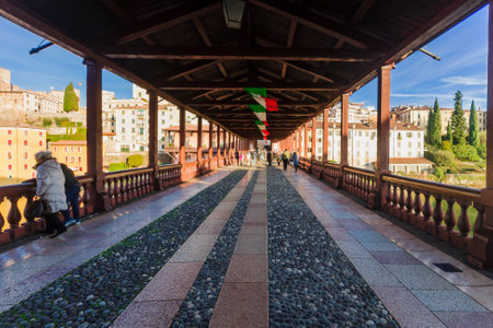 BASSANO DEL GRAPPA, ITALY - JAN 31, 2015: Scene of The Ponte Vecchio (or Ponte degli Alpini) bridge, with local and tourists, and the Brenta river, in Bassano del Grappa, Veneto, Italyのeditorial素材