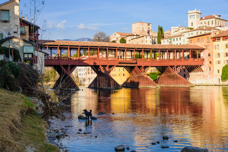 The Ponte Vecchio (or Ponte degli Alpini) bridge, and the Brenta river, in Bassano del Grappa, Veneto, Italyの写真素材