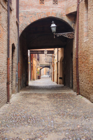 An alley in the old city of Ferrara, Emilia-Romagna, Italyの写真素材