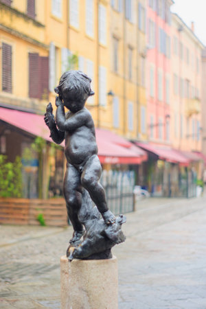 Statue and street scene in the historic center of Modena, Emilia-Romagna, Italyの写真素材