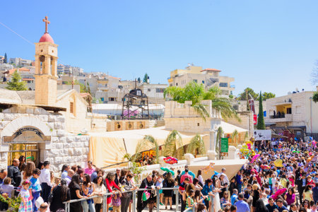NAZARETH, ISRAEL - APR 05, 2015: A crowd of prayers wait in front of the Greek Orthodox church of Annunciation, as part of the Orthodox Palm Sunday celebration, in Nazareth, Israelのeditorial素材