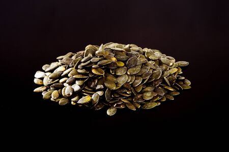 Pumpkin Seeds on a black backgroundの写真素材