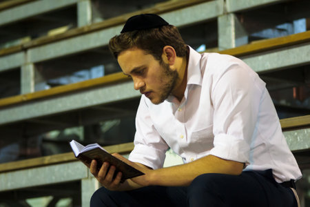 MERON ISR  MAY 06 2015: An orthodox Jew read a prayer book at the annual hillulah of Rabbi Shimon Bar Yochai in Meron on Lag BaOmer Holiday. Its an annual celebration at the tomb of Rabbi Shimonのeditorial素材