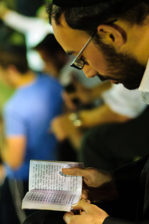 MERON ISR  MAY 06 2015: An orthodox Jew read a prayer book at the annual hillulah of Rabbi Shimon Bar Yochai in Meron on Lag BaOmer Holiday. Its an annual celebration at the tomb of Rabbi Shimonのeditorial素材