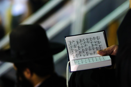 An orthodox Jew read a prayer book at the annual hillulah of Rabbi Shimon Bar Yochai in Meron on Lag BaOmer Holiday.の写真素材