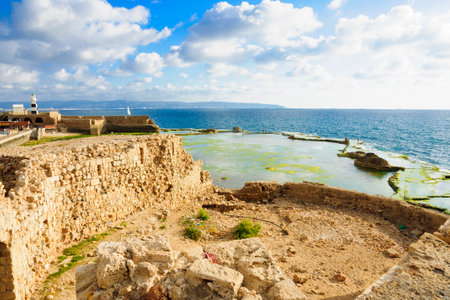 ACRE ISRAEL  MAY 04 2015: Scene of a Templar Fortress remains lighthouse restaurants local fishermen and Haifa bay in the old city of Acre Israelのeditorial素材