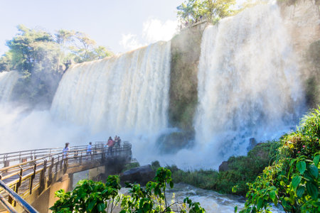 IGUASSU NATIONAL PARK ARGENTINA  SEPTEMBER 19 2009: Tourists admiring the mighty Iguassu waterfalls in Iguassu National Park on the border of Argentina and Brazil. Argentinian sideのeditorial素材