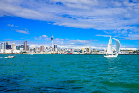 AUCKLAND NEW ZEALAND  APRIL 05 2010: Scene of the bay and skyline with the sky tower local boats and sailors in Auckland New Zealandのeditorial素材