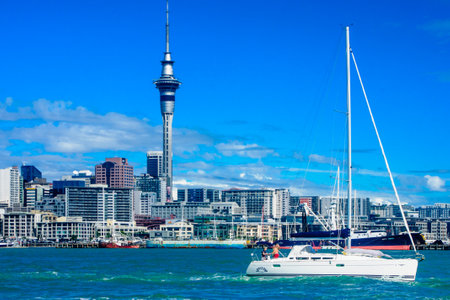 AUCKLAND NEW ZEALAND  APRIL 05 2010: Scene of the bay and skyline with the sky tower local boats and sailors in Auckland New Zealandのeditorial素材