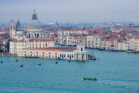 View of Santa Maria della Salute church, the Grand Canal, and local boats, in Venice, Veneto, Italyのeditorial素材