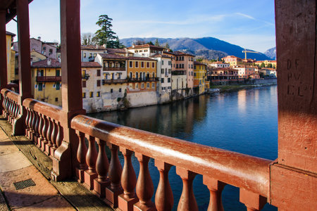 The Ponte Vecchio or Ponte degli Alpini bridge, and colorful houses on the Brenta river, in Bassano del Grappa, Veneto, Italyのeditorial素材