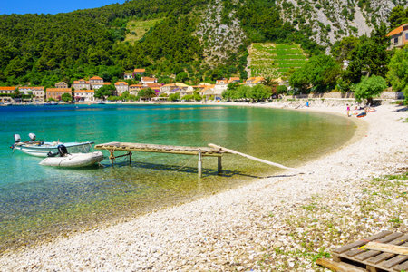 TRSTENIK, CROATIA - JUNE 25, 2015: View of the bay and the village, with locals and tourists, in Trstenik, Croatiaのeditorial素材