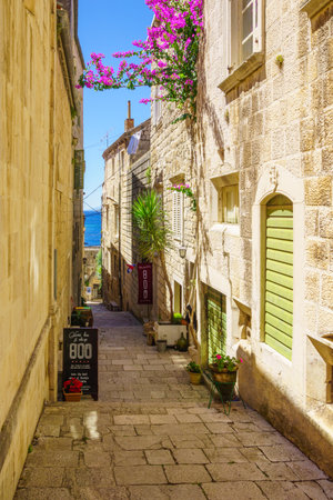 KORCULA, CROATIA - JUNE 25, 2015: An alley in the old city of Korcula, with local businesses, in Dalmatia, Croatiaのeditorial素材