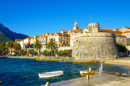KORCULA, CROATIA - JUNE 25, 2015: Scene of the western side of the old town, with houses, boats, locals and visitors, in Korcula, Croatiaのeditorial素材