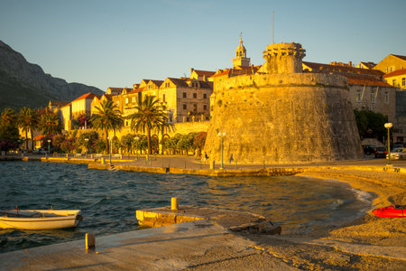 KORCULA, CROATIA - JUNE 25, 2015: Sunset scene in the old town west side, with the walls, houses, boats, locals and visitors, in Korcula, Croatiaのeditorial素材