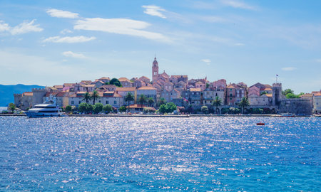 KORCULA, CROATIA - JUNE 26, 2015: Scene in the old town west side, with the walls, houses, boats, locals and visitors, in Korcula, Croatiaのeditorial素材