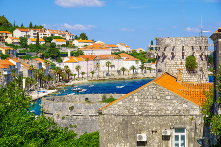 KORCULA, CROATIA - JUNE 26, 2015: Scene of the old town, with The Small Governor Tower, the bay, boats, locals and visitors, in Korcula, Croatiaのeditorial素材