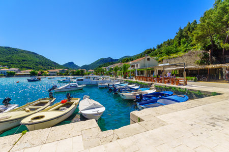 ZULJANA, CROATIA - JUNE 25, 2015: Scene of the port with cafes, boats, locals and tourists in Zuljana, Croatiaのeditorial素材