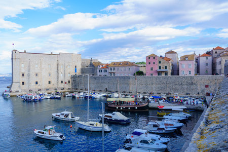 DUBROVNIK, CROATIA - JUNE 26, 2015: Scene of the port of the old city, with various boats, locals and tourists, in Dubrovnik, Croatiaのeditorial素材