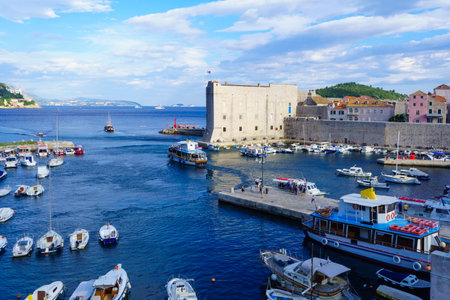 DUBROVNIK, CROATIA - JUNE 26, 2015: Scene of the port of the old city, with various boats, locals and tourists, in Dubrovnik, Croatiaのeditorial素材