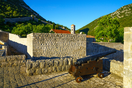 An old gun on the old walls in the village of Ston, in Dalmatia, Croatiaの写真素材