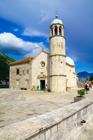 PERAST, MONTENEGRO - JUNE 28, 2015: Scene of Our Lady of the Rocks church, with local and tourists. On an artificial island in the Bay of Kotor, Montenegroのeditorial素材