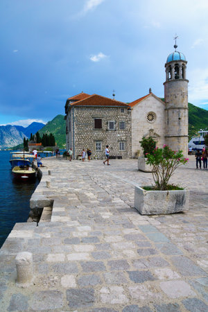 PERAST, MONTENEGRO - JUNE 28, 2015: Scene of Our Lady of the Rocks church, with local and tourists. On an artificial island in the Bay of Kotor, Montenegroのeditorial素材