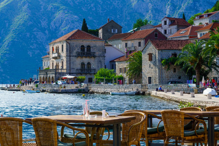 PERAST, MONTENEGRO - JUNE 28, 2015: Scene of the promenade, with cafes, old buildings, boats, locals and tourists, in Perast, Montenegroのeditorial素材