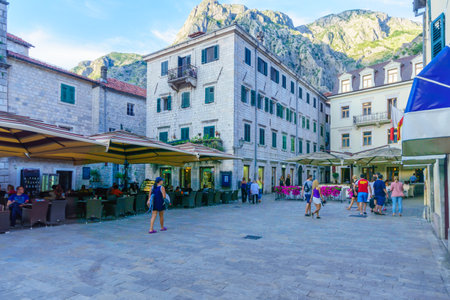 KOTOR, MONTENEGRO - JUNE 28, 2015: Scene of the Arms Square Trg od Oruzja, with cafes, locals and tourists, in Kotor, Montenegroのeditorial素材