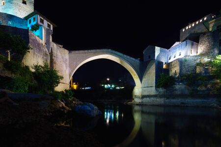 The old city and the restored Old Bridge Stari Most at night, in Mostar, Bosnia and Herzegovinaの写真素材