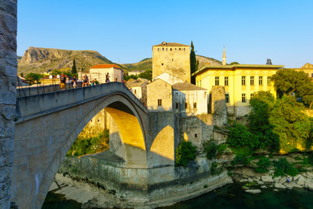 MOSTAR, BIH - JULY 05, 2015: Scene of the old city and the restored Old Bridge Stari Most, with locals and tourists, in Mostar, Bosnia and Herzegovinaのeditorial素材