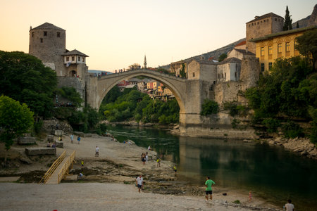 MOSTAR, BIH - JULY 05, 2015: The restored Old Bridge Stari Most on sunset, with locals and tourists, in Mostar, Bosnia and Herzegovinaのeditorial素材