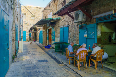 ACRE, ISRAEL - OCTOBER 01, 2015: Alley scene in the old city, with locals at a cafe, in Acre, Israelのeditorial素材