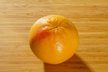 Red grapefruit on a wooden backgroundの写真素材