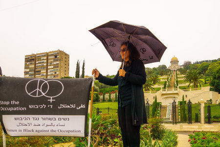 HAIFA, ISRAEL - NOVEMBER 06, 2015: Group of Women in Black in anti-war and anti-occupation protests, in the German Colony, near the Bahai Gardens. Haifa, Israelのeditorial素材