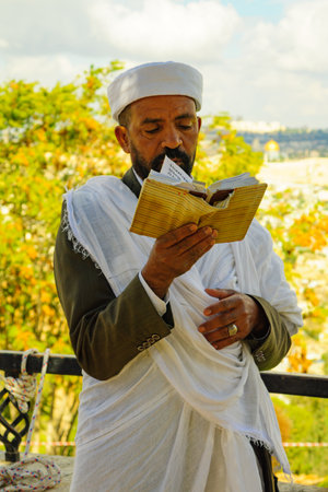 JERUSALEM, ISRAEL - NOVEMBER 11, 2015: An Ethiopian Jewish man pray at the Sigd, with the old city in the background, in Jerusalem, Israel. The Sigd is an annual holiday of the Ethiopian Jewryのeditorial素材