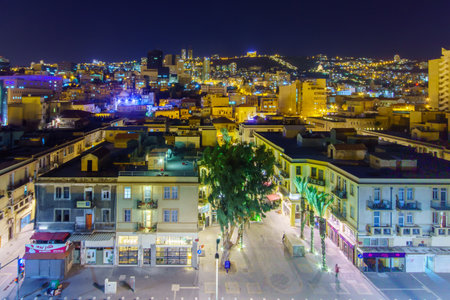 HAIFA, ISRAEL - NOVEMBER 23, 2015: Night scene of downtown, with the renewed Turkish market, the slopes of Mount Carmel, the Bahai Gardens, local businesses, locals and tourists, in Haifa, Israelのeditorial素材