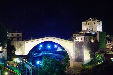 The old city and the restored Old Bridge Stari Most at night, in Mostar, Bosnia and Herzegovinaの写真素材