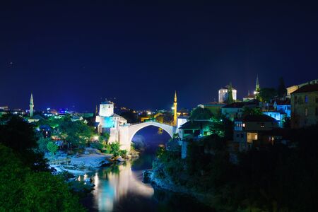 The old city and the restored Old Bridge Stari Most at night, in Mostar, Bosnia and Herzegovinaの写真素材