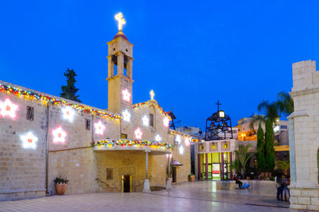 NAZARETH, ISRAEL - DECEMBER 16, 2015: Scene of the Greek Orthodox Church of the Annunciation, with a Christmas tree, locals and tourists, in Nazareth, Israelのeditorial素材