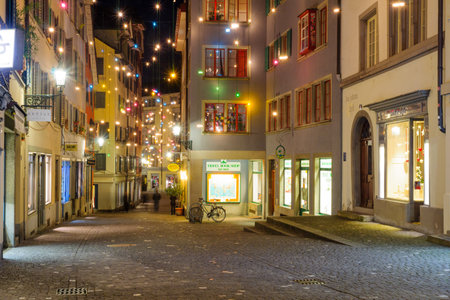 ZURICH, SWITZERLAND - DECEMBER 24, 2015: Night street scene in the Old Town Altstadt, with Christmas decoration lamps in multiple colors, in Zurich, Switzerlandのeditorial素材