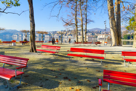 LUGANO, SWITZERLAND - DECEMBER 29, 2015: View of the Parco Civico garden and the lakefront, with locals and visitors, in Lugano, Ticino, Switzerlandのeditorial素材