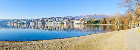 LUGANO, SWITZERLAND - DECEMBER 29, 2015: Panoramic view of the Parco Civico garden and the lakefront, with locals and visitors, in Lugano, Ticino, Switzerlandのeditorial素材