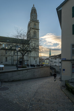 ZURICH, SWITZERLAND - DECEMBER 24, 2015: Sunset view of the Grossmunster great minster Church, with locals and visitors. In Zurich, Switzerlandのeditorial素材