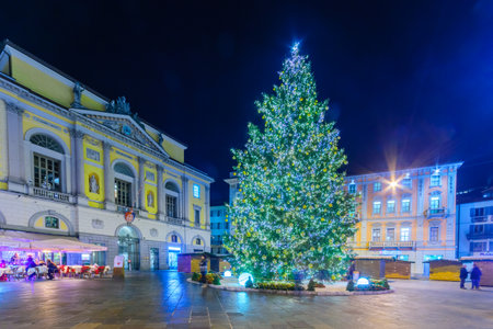 LUGANO, SWITZERLAND - DECEMBER 29, 2015: Evening scene in Piazza della Riforma Reform square, with Christmas tree and decorations, locals and visitors, in Lugano, Ticino, Switzerlandのeditorial素材