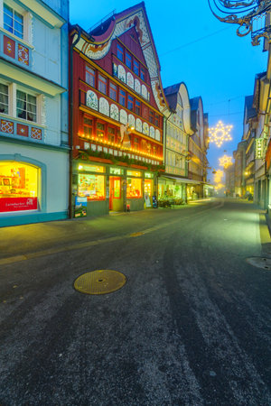 APPENZELL, SWITZERLAND - DECEMBER 30, 2015: Evening scene with painted houses, Christmas decorations, locals and visitors, in Appenzell, Switzerlandのeditorial素材