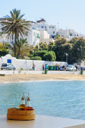 MYKONOS, GREECE - OCTOBER 02, 2011: Village and beach scene, with local businesses, windmills, locals and visitors, in Mykonos, Mykonos Island, Greeceのeditorial素材