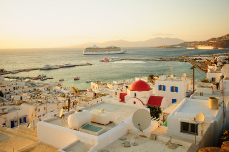 MYKONOS, GREECE - OCTOBER 02, 2011: Sunset scene of the Village and port, with local businesses, vessels, locals and visitors, in Mykonos, Mykonos Island, Greeceのeditorial素材