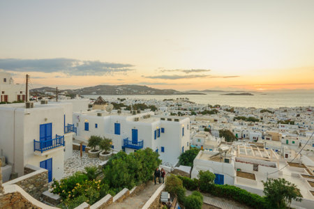 MYKONOS, GREECE - OCTOBER 02, 2011: Sunset scene of the Village, with local businesses, windmills, locals and visitors, in Mykonos, Mykonos Island, Greeceのeditorial素材