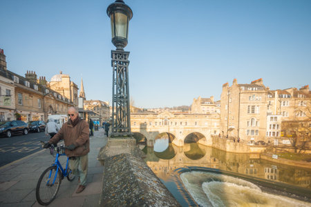 BATH, UK - FEBRUARY 19, 2013: View of the Pulteney Bridge, with locals and visitors, in Bath, Somerset, Englandのeditorial素材